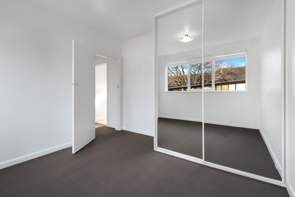corner empty new room with white walls wardrobe with mirror sliding doors web
