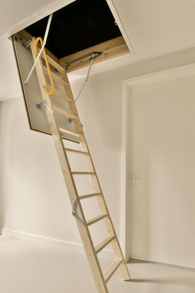 ladder hanging from ceiling room that has been painted white is being used construction purposes web
